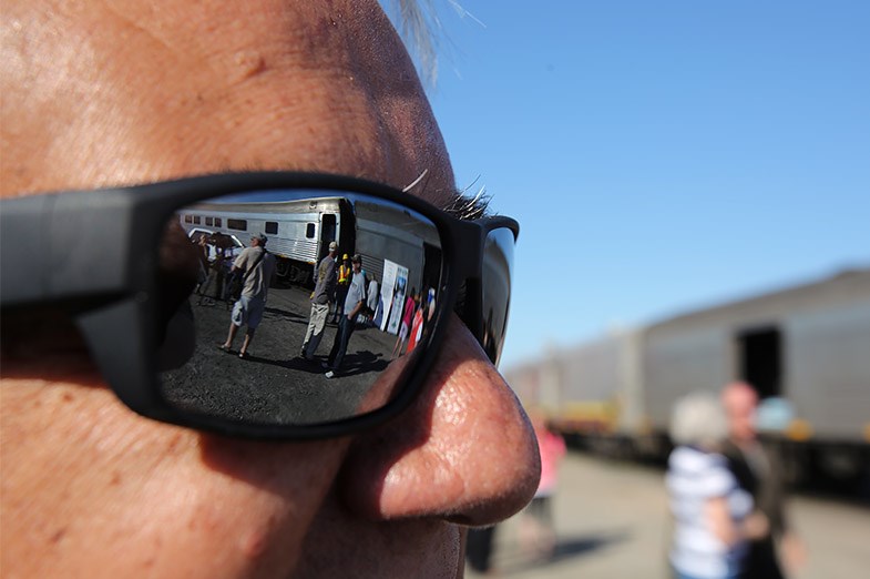 The ACR train and passengers are reflected in Sault Ste. Mariie city CAO Joe Fratesi's sunglasses May 31, 2014. Fratesi was is a member of Algoma Passenger Train Working Group, who fought to negotiate an extension of the government subsidy that allows the train to continue to run. He was present Saturday morning to see the train off for it's 100th anniversary voyage from Sault Ste. Marie, Ont. to Hearst, Ont. SooToday.com/Kenneth Armstrong