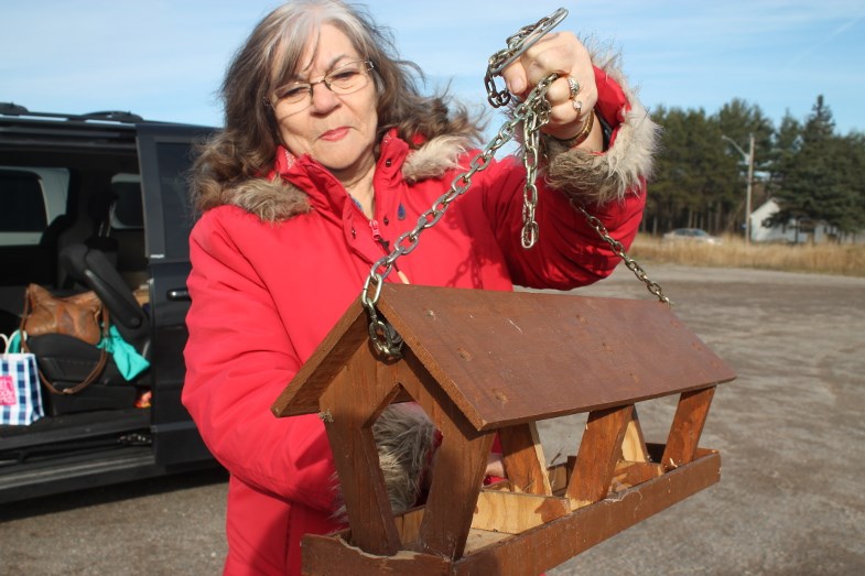 Merlene Lee with wooden bird feeder