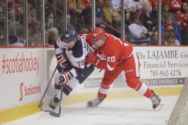 Saginaw Spirit defenceman Jacob Ringuette and Nick Ritchie of the Soo Greyhounds battle for control of the puck during game two of their playoff series on March 28, 2015 at the Essar Centre in Sault Ste. Marie. Kenneth Armstrong/SooToday