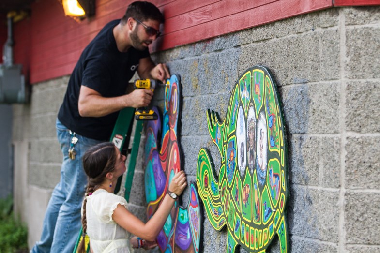 Volunteers install the second Mill Market Project panel prior to the reveal on Wednesday, September 2, 2015. Donna Hopper/SooToday