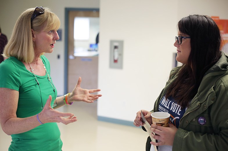Kara Flanagan, local candidate for the Green Party, speaks to a volunteer during an all-candidate meet and greet today at Algoma University. Kenneth Armstrong/SooToday