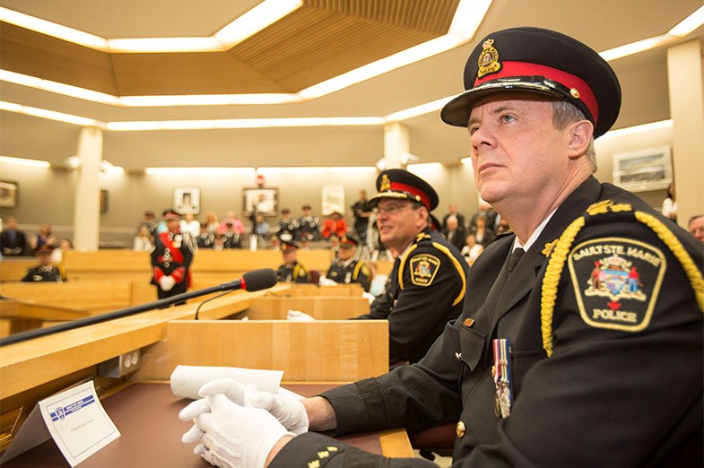 Outgoing Police Chief Bob Davies listens to a speaker during the swearing-in of the Police Chief Bob Keetch June 16, 2014 in Sault Ste. Marie, Ont. SooToday.com/Kenneth Armstrong