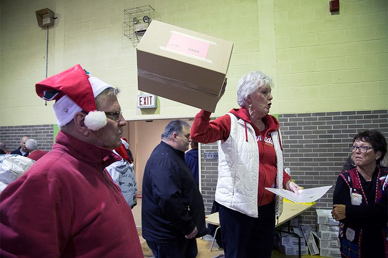 Jill Raycroft, head packing volunteer, instructs other volunteer on how to pack boxes for Christmas Cheer during an event December 18, 2014 at the former Sir James Dunn. Kenneth Armstrong/SooToday