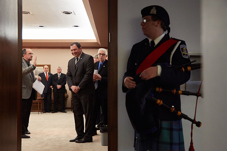A bagpiper stands outside while the mayor-elect and council-elect receive their final instructions prior to the city council inauguration on December 1, 2014 at the Civic Centre. Kenneth Armstrong/SooToday
