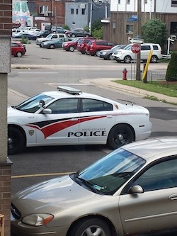 A cruiser and a second vehicle are pictured in accessible parking spots at a building at Albert and McDougald Streets. Photo supplied.