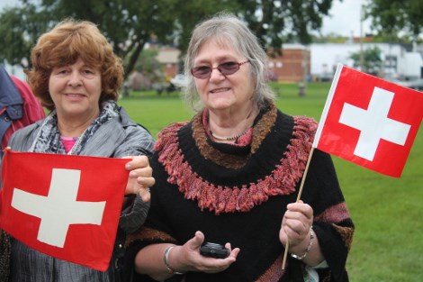 Maria Niessl and Nora Buhlmann wave Swiss flags