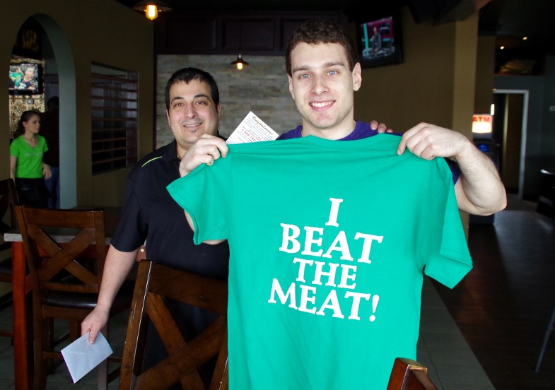 Jonathan Clarke shows off the 'I Beat the Meat' t-shirt presented to him by pub manager John Perri. Michael Purvis/SooToday.com
