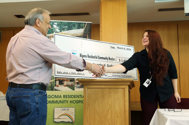 City CEO Joe Fratesi presents an oversized cheque to Lee Skinner from ARCH.