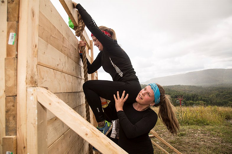 Teammates assist each other over the wall obstacle during the Muddy Moose Charge at Searchmont Resort on September 13, 2014. SooToday.com/Kenneth Armstrong