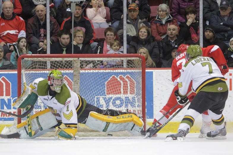 Soo Greyhounds forward Michael Bunting scores on Jake Smith of the North Bay Battalion during a game on February 20, 2015 at the Essar Centre in Sault Ste. Marie. Kenneth Armstrong/SooToday