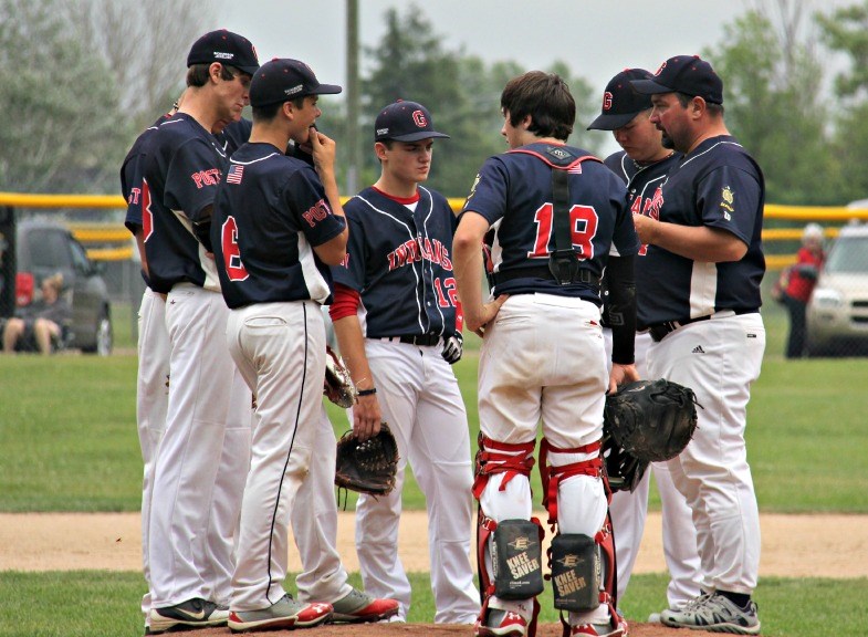 The Gladstone Indians talk strategy between hitters