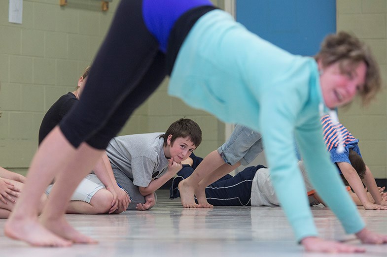 Rosedale Public School student Austin Duguay watches as Nancy Neave demonstrates a yoga position during a fundraiser June 5, 2014. SooToday.com/Kenneth Armstrong