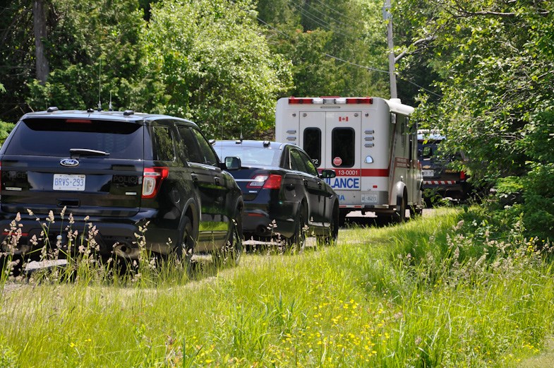 An ambulance joined the number of OPP vehicles parked in front of a home in Hilton Beach Saturday. Donna Schell for SooToday