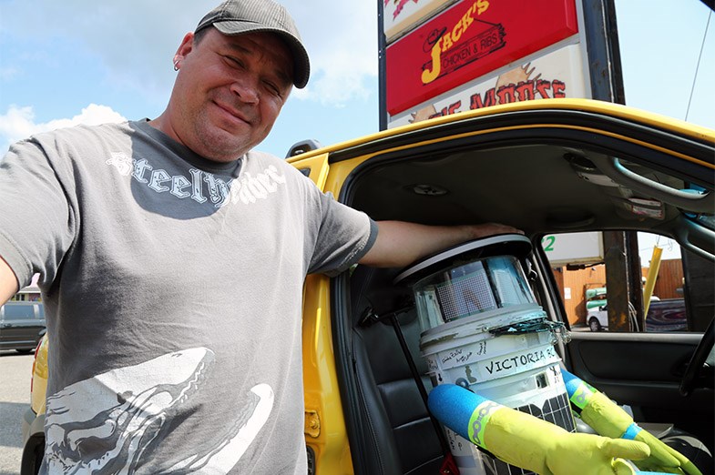 Henry Lewis seen August 5, 2014 with hitchBOT in the passenger seat of his car. SooToday.com/Kenneth Armstrong