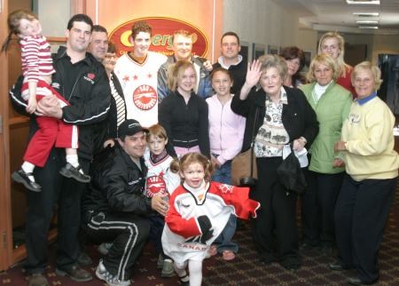<b>Brett Perlini with his family and a new group of Greyhound season ticket holders.</b>