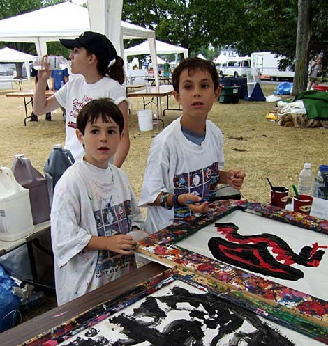 Francisco and Nicolas Bullrich continue painting under a tent