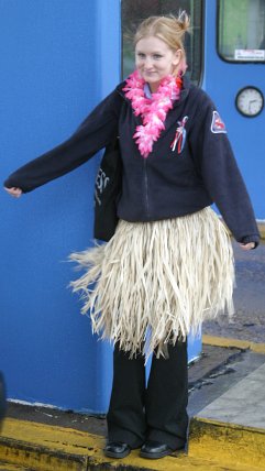 Woman wears grass skirt on bridge people give her money Sault