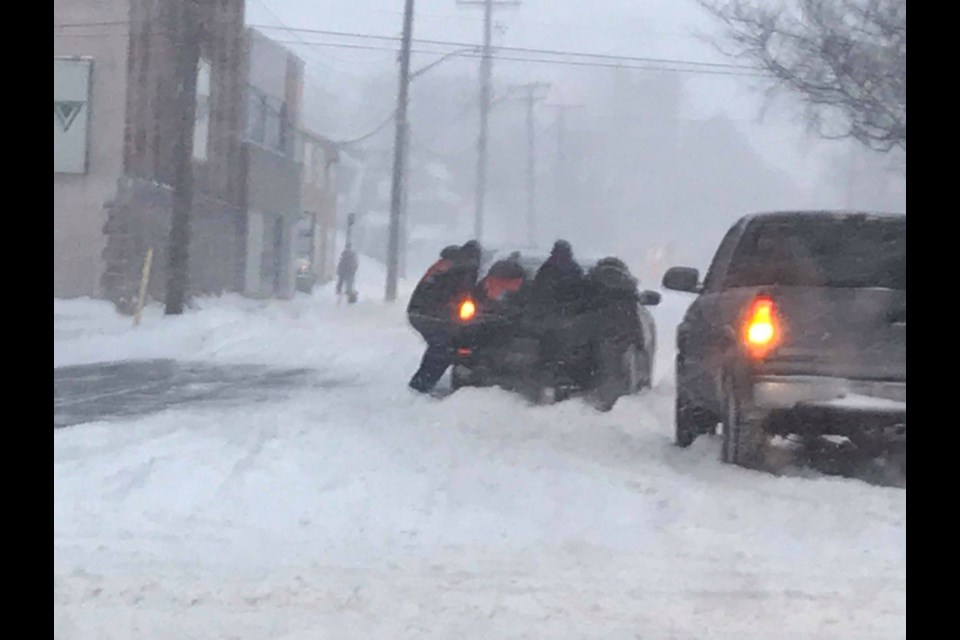 Josh and Bethany Jansen took the time to help push vehicles out of Monday record breaking snowfall. Photo supplied