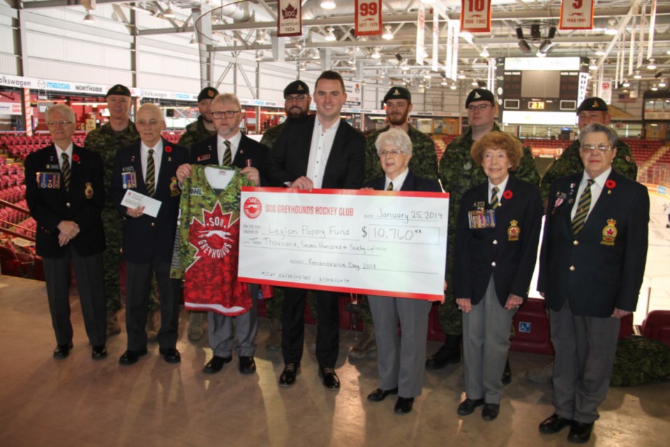 Kyle Raftis, Soo Greyhounds general manager, presents a cheque for $10,760 on behalf of the hockey club to Royal Canadian Legion Branch 25 officials for the Branch’s Poppy Fund, Jan. 25, 2019. Darren Taylor/SooToday