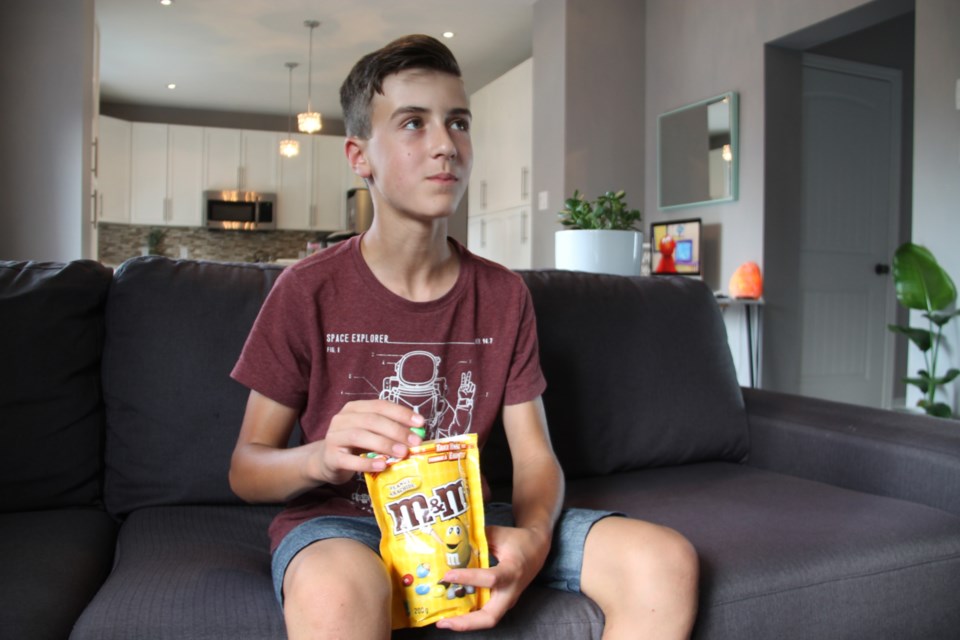 Lennon Turco happily chomps on M&M's candy after completing a clinical trial designed to treat a peanut allergy, July 16, 2019. Darren Taylor/SooToday 