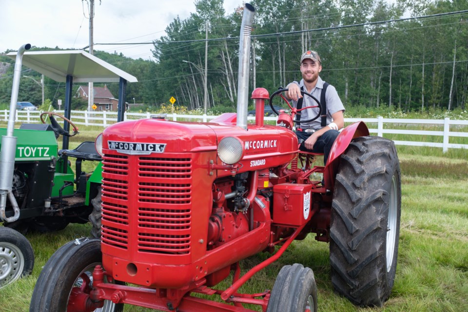 Daniel Black sits on his great grandfather Fred Woolley's 1953 McCormick W-4 tractor at the 2017 Prince Township Tractor Cruise on August 5. Jeff Klassen/Sootoday
