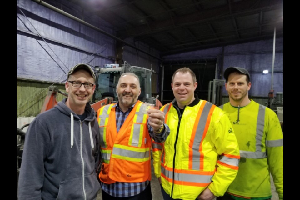 GFL Environmental’s Dan DiPietro, John Martella, Chris Dovigi and Andrew Miron, Martella holding up a Sault woman’s lost diamond ring retrieved from 40 tonnes of recyclable paper items at GFL’s Sackville Road plant, March 26, 2020. Photo supplied
