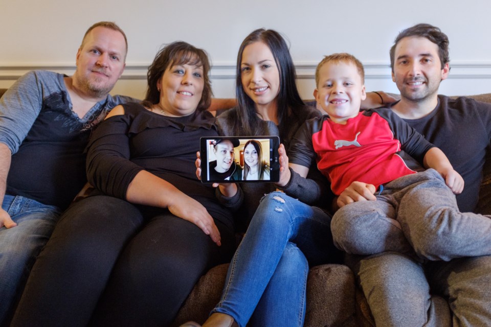 Ryan Catling (via Facetime on tablet screen) was diagnosed with Acute Myeloid Leukemia in August. Since then his girlfriend Amanda Levar (also in tablet) has sacrificed her schooling to take care of him and his sister Jessica Catling (holding tablet) is donating her stem cells to make sure he can live. He also has support from (from left) his dad Robert, mom Franca, brother Lucas, 7, and Jessica's boyfriend Dan Vernelli. Jeff Klassen/SooToday