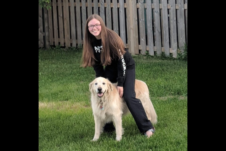 Sarah Nelson, now 15 and retired from her baking business, seen in a recent photo with her dog Macker Boy. Photo provided by Sarah Nelson 