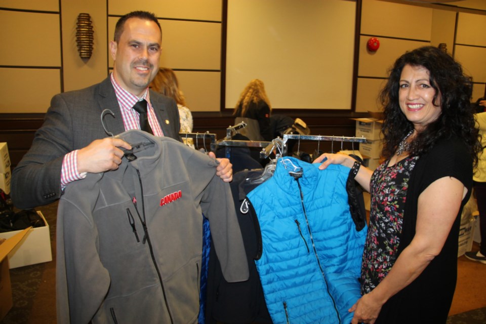 Sonny Spina, Algoma Family Services Foundation chair, and Sherry Berlinghoff, SK Group president, with new, high quality clothing made available to local charities, May 24, 2019. Darren Taylor/SooToday 