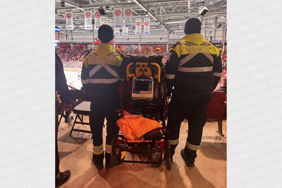Sault paramedics Mitchell Boyle and Jay Ceskauskas stood by Gary Duke’s stretcher and administered oxygen as he enjoyed one final Soo Greyhounds game, Feb. 23, 2025.