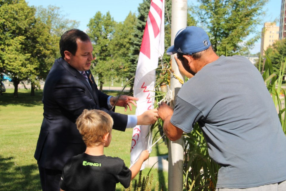 Sault Mayor Christian Provenzano with Terrance Boston, 10, a child currently in remission after battling cancer, and Dominic Campioni, whose daughter Angela passed away from childhood cancer, raising the Northern Ontario Families of Children with Cancer (NOFCC) flag prior to proclaiming September to be Childhood Cancer Awareness Month in Sault Ste. Marie, Sept. 10, 2018. Darren Taylor/SooToday