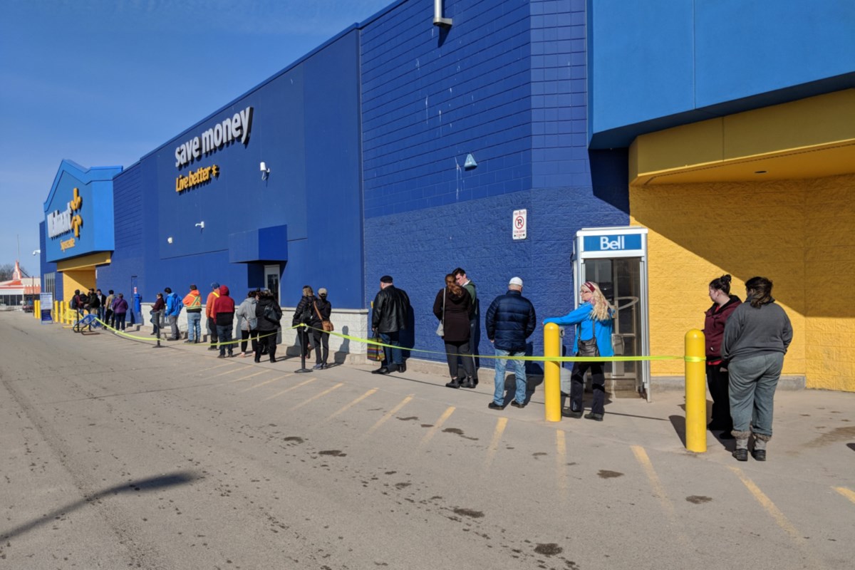 Shoppers line up to enter stores due to virus concerns (9 photos