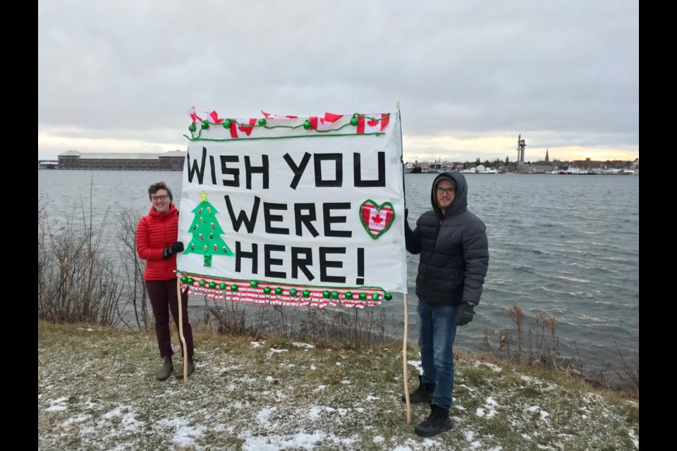 The Sault’s Katie and Dan Elliott greeted Sault, Michigan family members across the still closed to non-essential travel Canada-U.S. border with a sign and binoculars, Dec. 24, 2020. Photo supplied