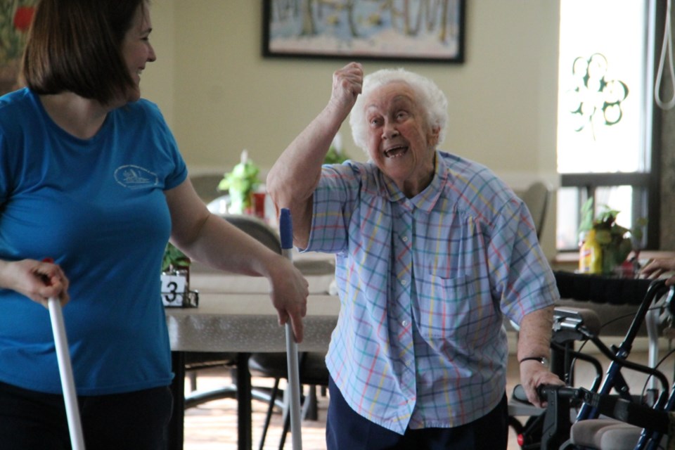 Kay Stewart, an Ontario Finnish Resthome resident, reacts jubilantly at a recreational, intergenerational indoor curling event with Kiwedin Public School Grade 1 students at the rest home, March 21, 2018. Darren Taylor/SooToday