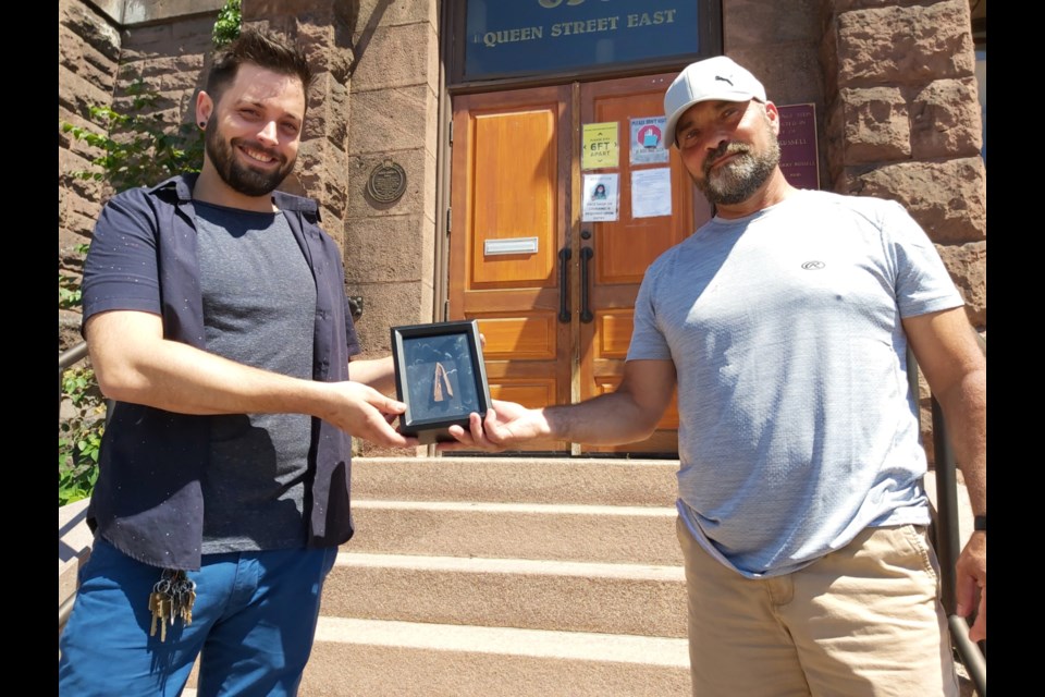 Rob Gioia (right), Sault metal detector enthusiast, donates a copper object, possibly a spear tip, which he discovered on the shores of the St. Marys River and verified as being 3,000 to 5,000 years old, in a shadow box to William Hollingshead, Sault Ste. Marie Museum executive director and chief curator, July 24, 2020. Darren Taylor/SooToday 