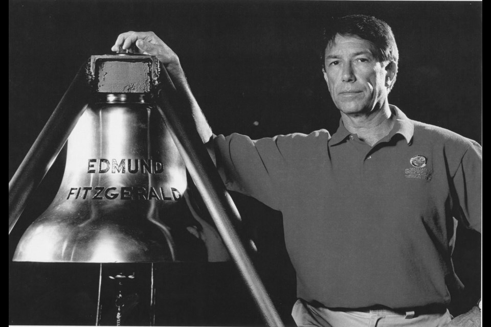 Tom Farnquist, beside the ships bell recovered from the Edmund Fitzgerald. Photo by Chris Winters, courtesy of Tom Farnquist. Photo provided