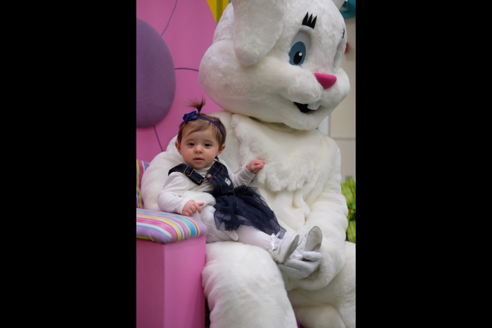 Ella, 9, sits on the Easter Bunny's lap at the Station Mall on Saturday. Photo by Jeff Klassen for SooToday