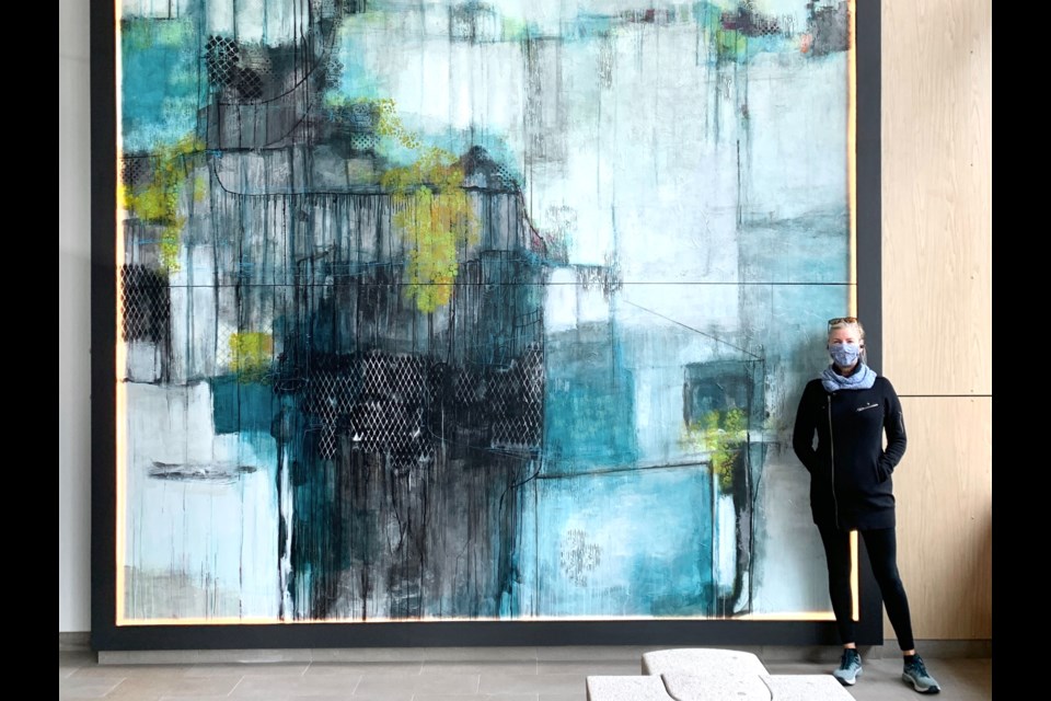 Lori Mirabelli's 18x13 foot abstract painting seen in a condominium lobby in Toronto with a friend standing next to the work to show size. 