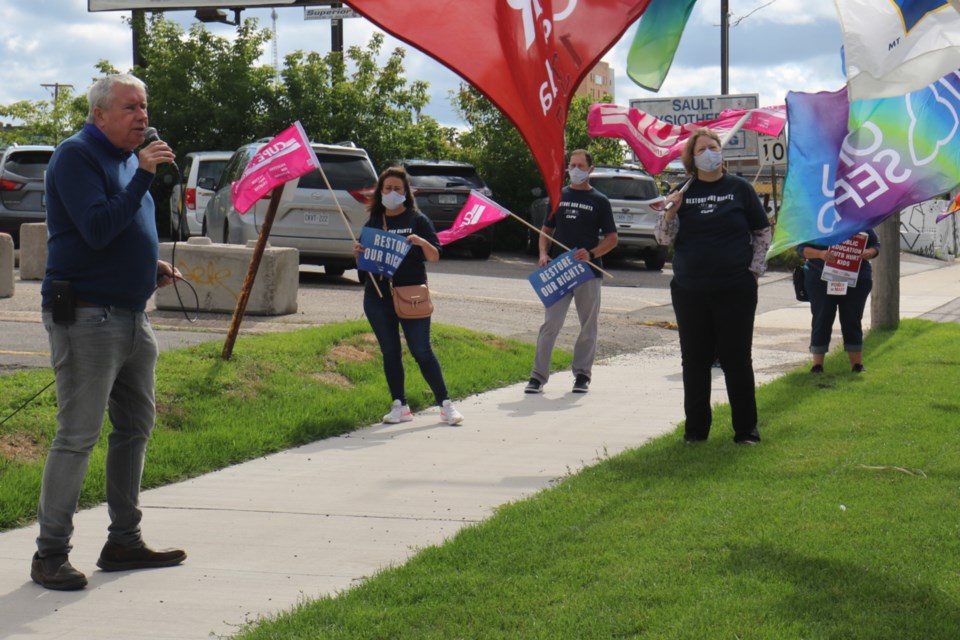Ontario Council of Hospital Unions (OCHU) President and CUPE Ontario First Vice-President Michael Hurley, left, speaks to local front-line workers and union representatives outside of Sault Ste. Marie MPP Ross Romano's office Wednesday. James Hopkin/SooToday