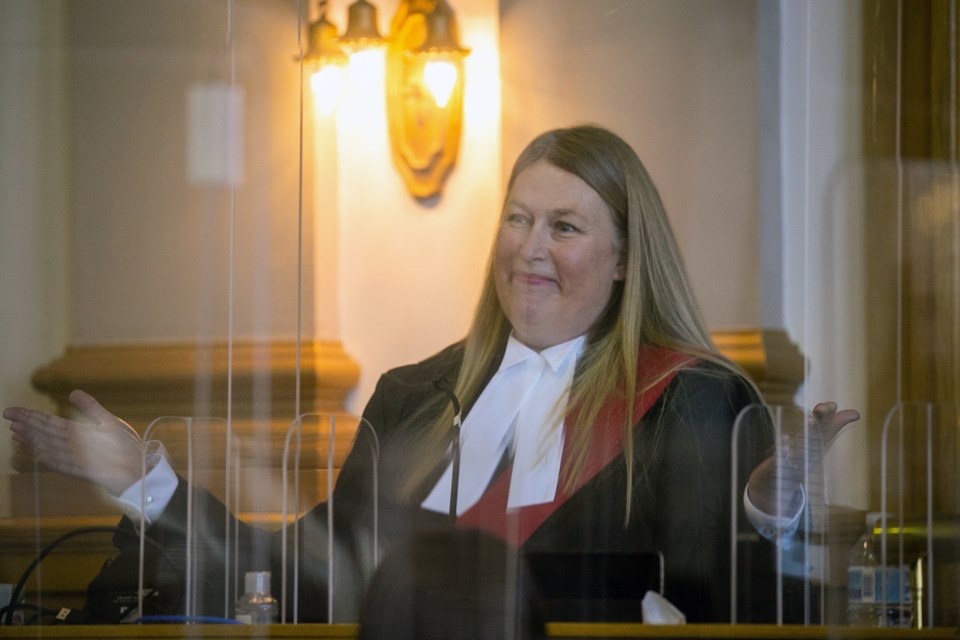 Justice Dana Peterson makes an expression immediately after taking a seat behind the bench during her swearing-in ceremony as a judge of the Ontario Court of Justice on April 28, 2022.