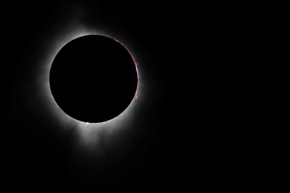 A corona surrounds the moon as the solar eclipse reached its peak in Burlington