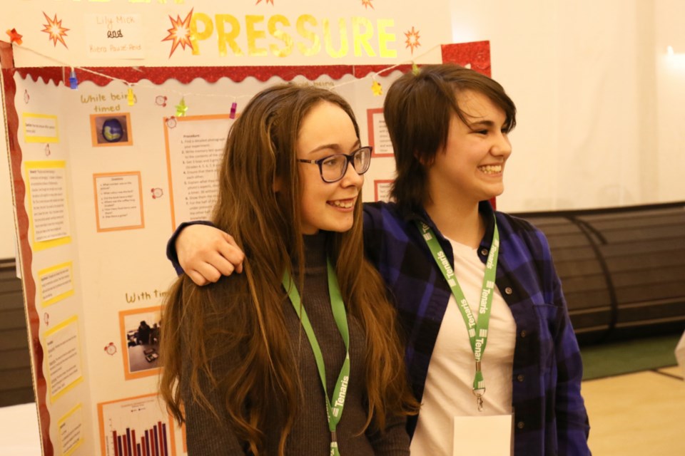 Lily Mack, left, and Kiera Pauze-Reid pose in fron of their award-winning science project, Under Pressure, at the 32nd annual Rotary Science Fair Algoma at the George Leach Centre Saturday. James Hopkin/SooToday 