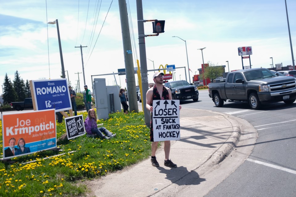 After coming in last place in a fantasy hockey league, Brian Ducharme was forced to wear a dress and stand at the corner of Great Northern Road and Second Line West on Saturday. Jeff Klassen/SooToday