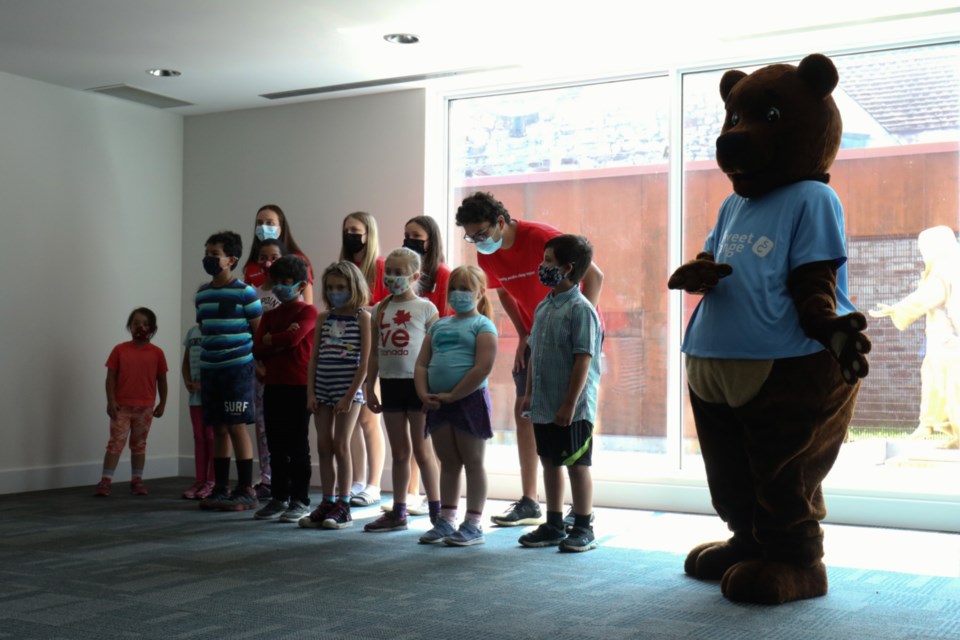 Sweet Change the Chocolate Bear joined local children to sing the official song of the new Sweet Change Good Deeds program at The Gathering Place Wednesday.