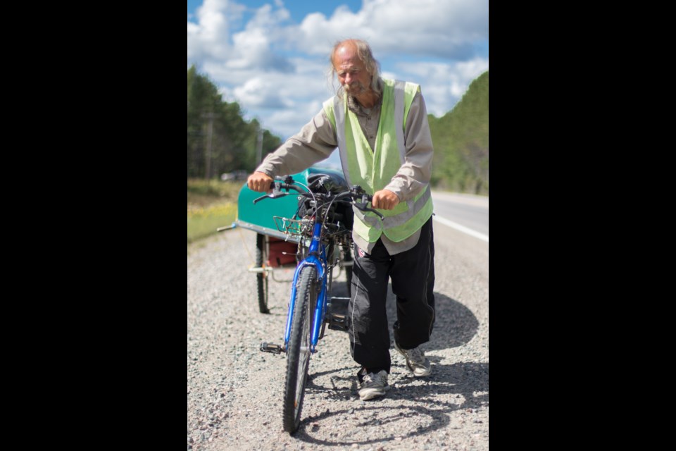 This man was interviewed by SooToday on Sept. 15, 2016 pushing a bicycle and canoe eastbound along Highway 17 near Espanola. Eight years later, the OPP has confirmed he is the same man whose body washed up on a beach north of Port Albert on Oct. 15, 2016. Jeff Klassen/SooToday