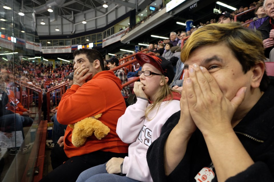 (L to R) Jason Hebert, Morgan Pressel, and Doris Hughes felt the intensity of Thursday's Greyhounds game more than anyone else. Super-fan Hebert, and his good-luck stuffed-bear Taber, sit right behind the player's bench during every one of the team's home games. Photo by Jeff Klassen for SooToday