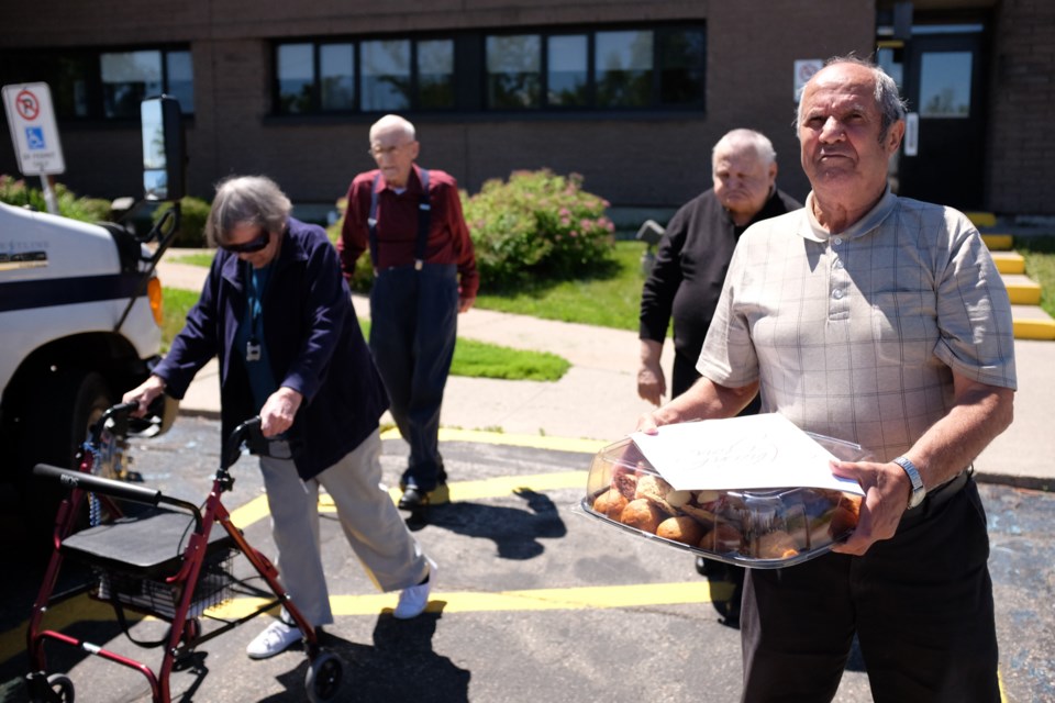 Residents of the Ontario Finnish Resthome baked and delivered treats to various emergency services organizations on Wednesday. (Left to right is June Harbottle, 88, Calvin Campbell, 88, Mike Koivisto, 67, and Tito Consoli, 72). Photo by Jeff Klassen for SooToday