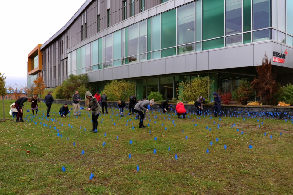 1,100 blue flags were planted on the campus Sault College Wednesday as part of Learning Disabilities Awareness Month. Each flag represents a local student who's been identified as living with a learning disability. James Hopkin/SooToday