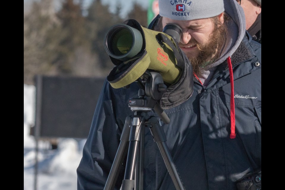 Carter Dorscht, of Dorscht Birding, scoping the distant Gyrfalcon. Violet Aubertin for SooToday