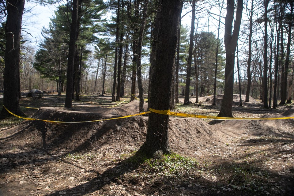 Caution tape hung from the trees surrounding the pump track at Kinsmen Park. The Sault Cycling Club said on its Facebook page on Monday the track is closed due to a 'large amount of broken glass being found in the fill.' 